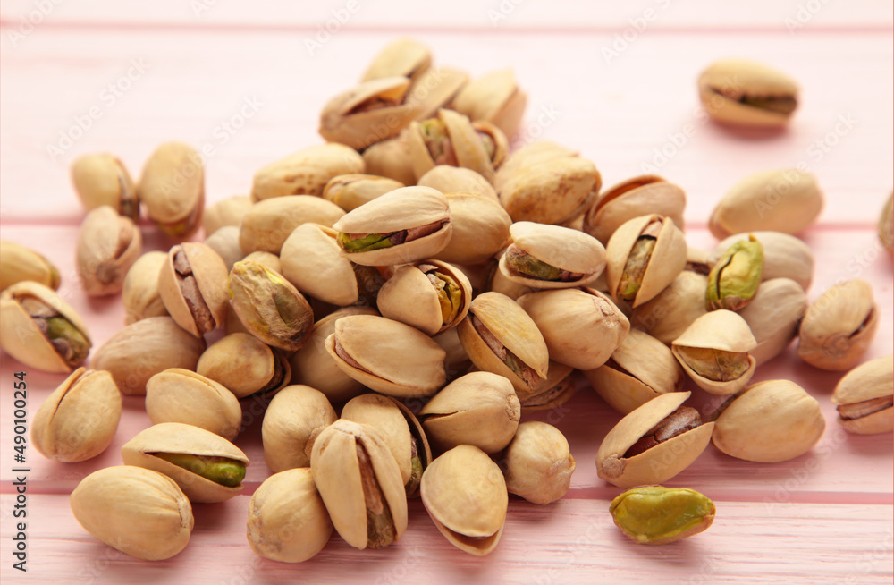 Pile of Pistachios on the pink background. Pile of Pistachios on the pink background.