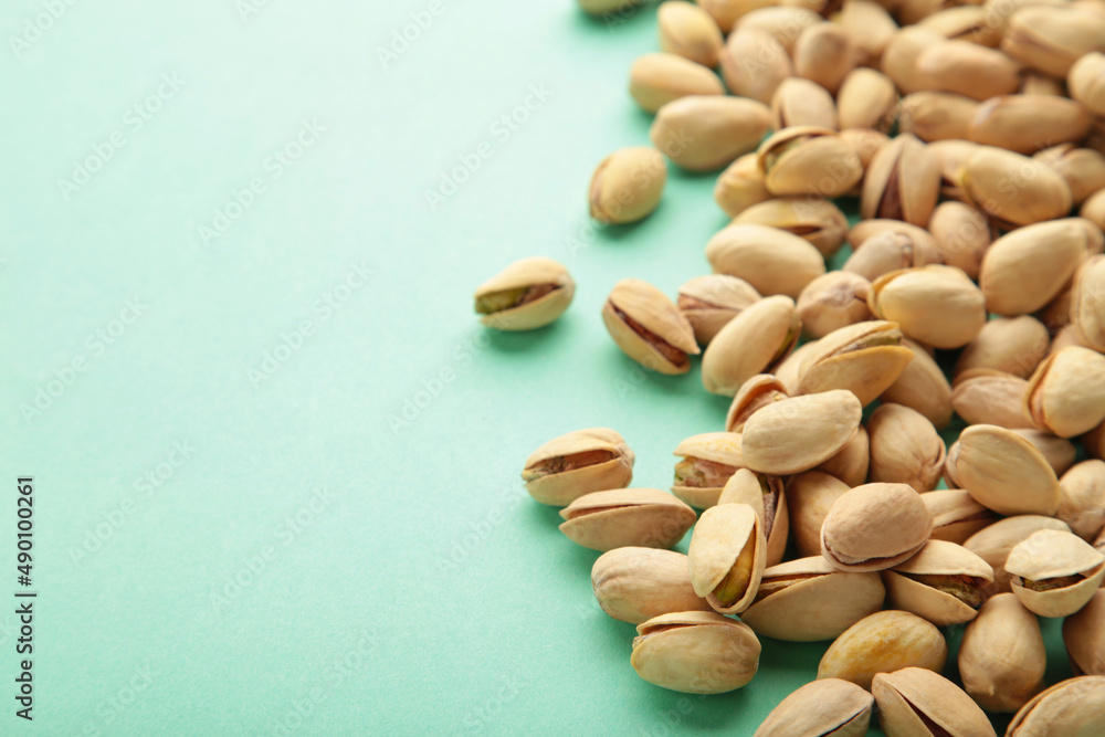 Pile of Pistachios on the green background. Pile of Pistachios on the green background.