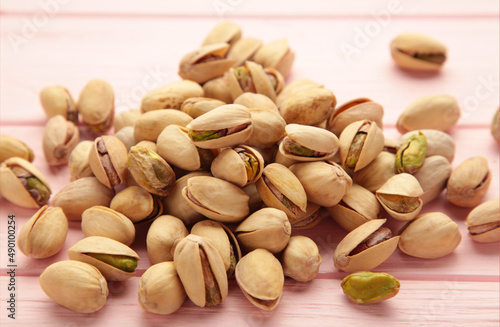 Pile of Pistachios on the pink background.