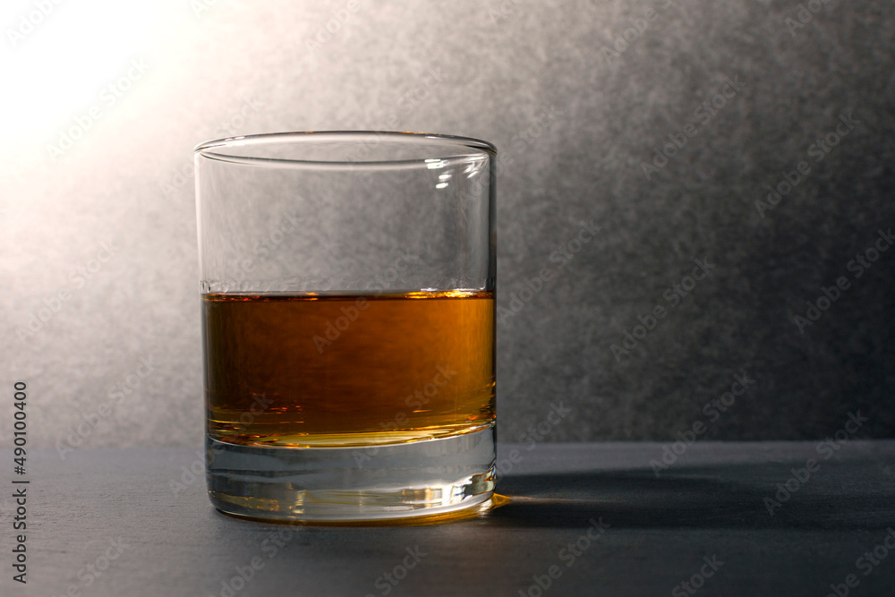 glass goblet with whiskey on a dark background glass goblet with whiskey on a dark background