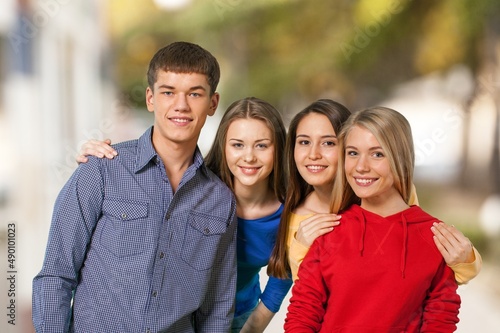 Wallpaper Mural Attractive college friends smiling and hugging while carrying notebooks at class Torontodigital.ca