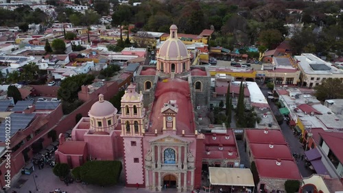 Partial Orbit Shot around Santa María de la Asunción Parish Church, with a Reveal of the Beautiful Plaza Miguel Hidalgo Afterwards at Dusk in Tequisquiapan, Queretaro in Mexico photo