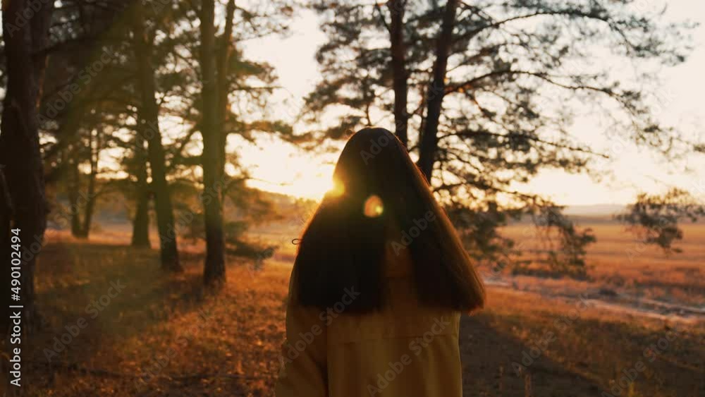 Girl walks through natural forest. Woman hiking alone. Teenager girl in nature at sunset. Fantasy of people in park in autumn. Active lifestyle. People in forest. Tourist walk in autumn forest park Girl walks through natural forest. Woman hiking alone. Teenager girl in nature at sunset. Fantasy of people in park in autumn. Active lifestyle. People in forest. Tourist walk in autumn forest park