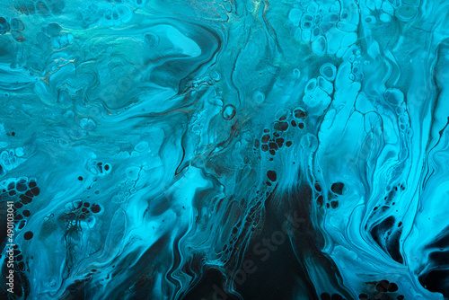 Fluid Art. Blue abstract wave swirls on black background. Marble effect background or texture © colnihko