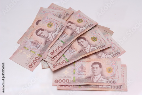 Fotografija 1000 baht Thai banknotes placed on a white background.