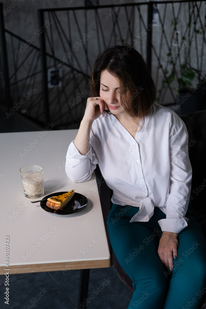 woman in white blouse in a cafe with a cup of coffee and dessert. coffee break. business woman. woman in white blouse in a cafe with a cup of coffee and dessert. coffee break. business woman.