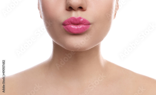 Closeup view of beautiful woman puckering lips for kiss on white background