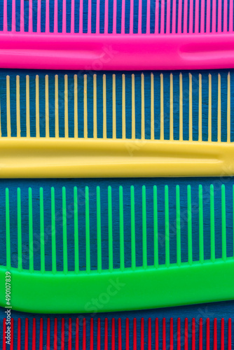 A set of multi-colored combs close-up. Vertical photography.