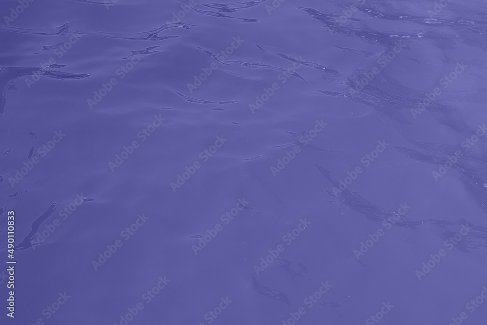 blue water wave texture background. Rippled water. Shiny purple and blue water surface.