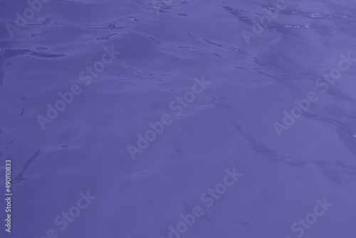 blue water wave texture background. Rippled water. Shiny purple and blue water surface.
