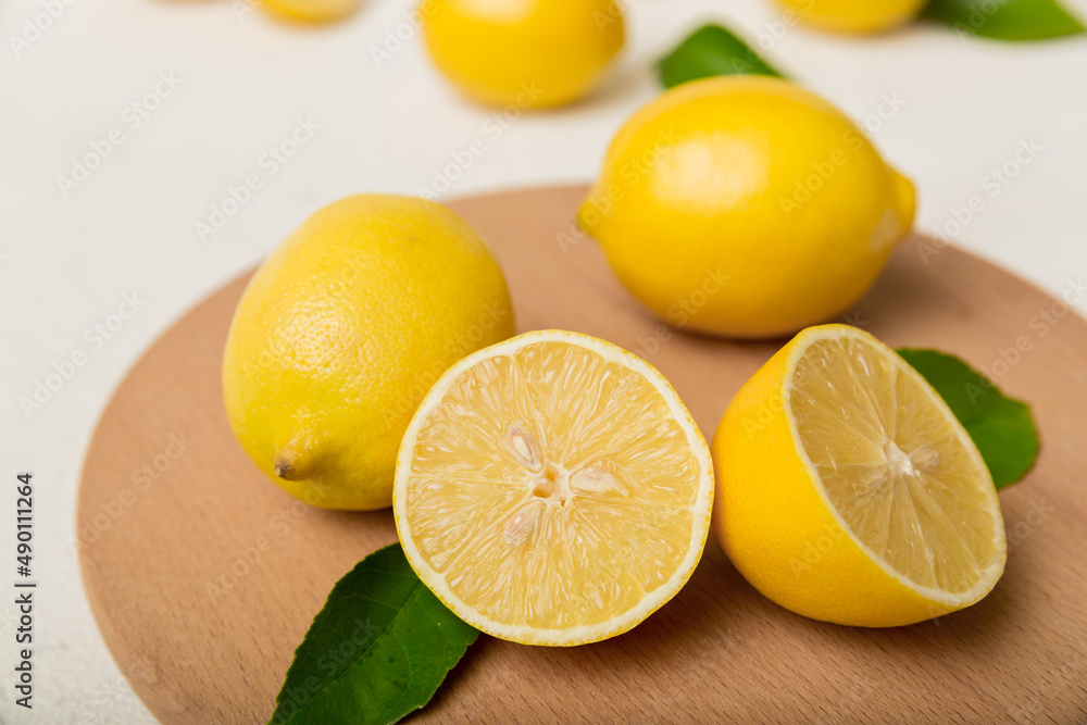 Top view with copy space for fresh and ripe lemons on cutting board. Healthy food background. Elegant background of lemon and lemon slices with squeezer colored background Top view with copy space for fresh and ripe lemons on cutting board. Healthy food background. Elegant background of lemon and lemon slices with squeezer colored background