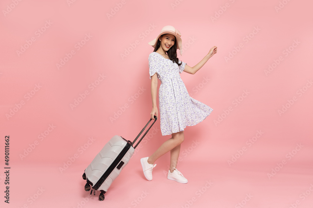 Premium Photo  Girl traveller with pink suitcase. pink travel bag and girl  holding it. picture of girl from the back. girl taking pink travell bag on  white background.