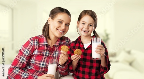 Little girl drinking tasty chocolate milk at home concept