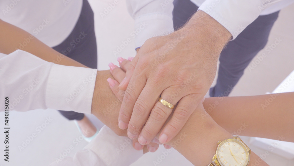 Group of people holding hands at work Group of people holding hands at work