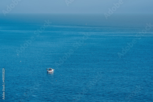 seascape with a lonely fishing boat, view from above © Evgeny