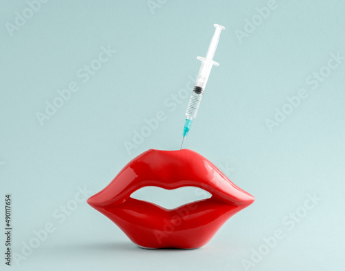 Konstfotografi Red lips and syringe on blue background