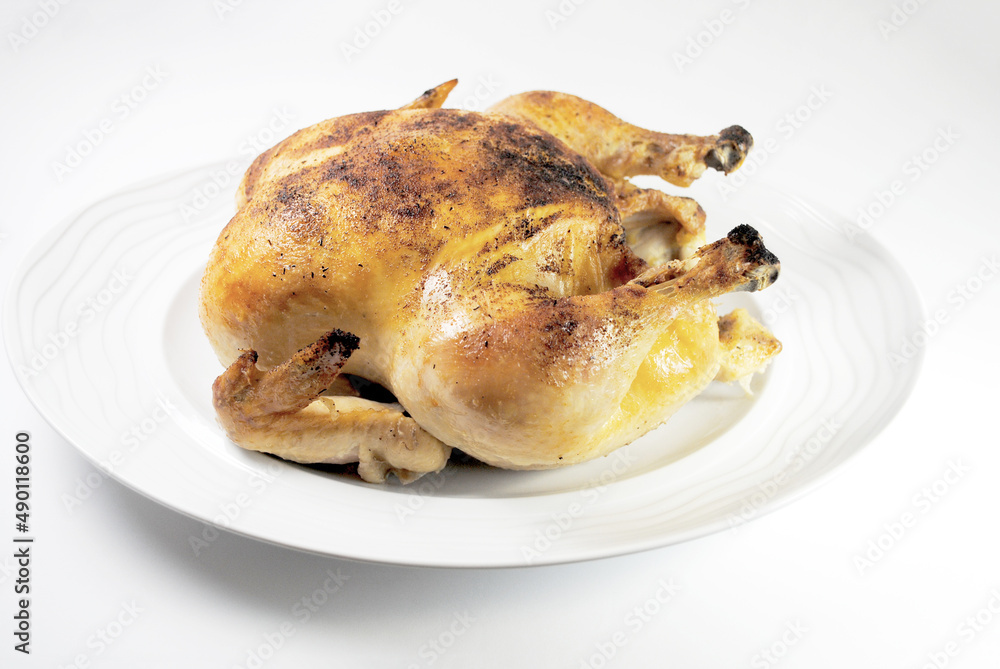 Whole Roasted Chicken on a Round White Platter Whole Roasted Chicken on a Round White Platter