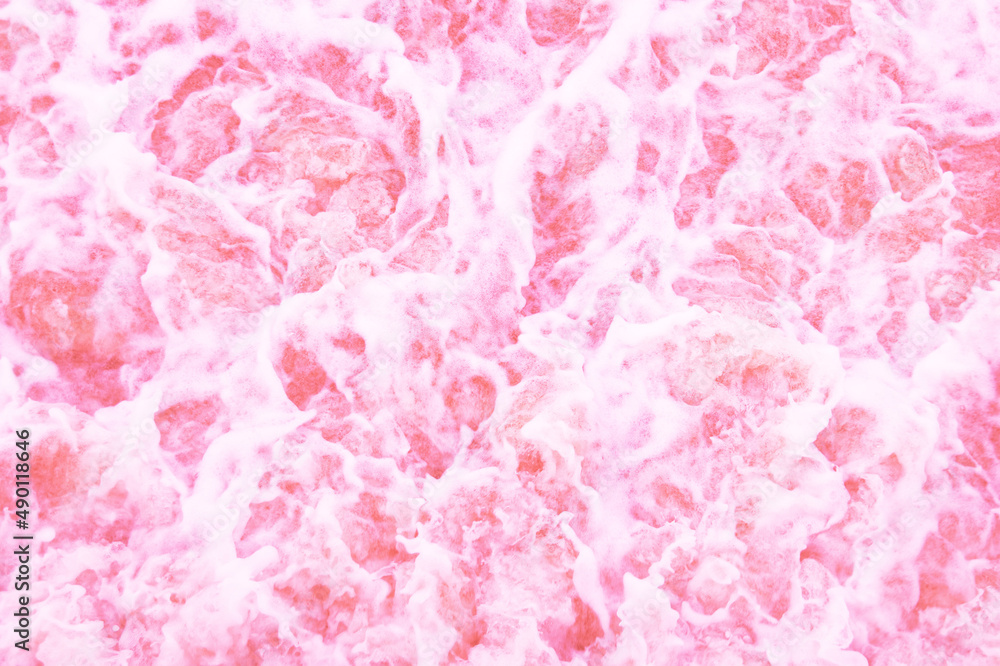 Unfocused abstract background . Colorful foam with bubbles in the water. The texture of pink foam..