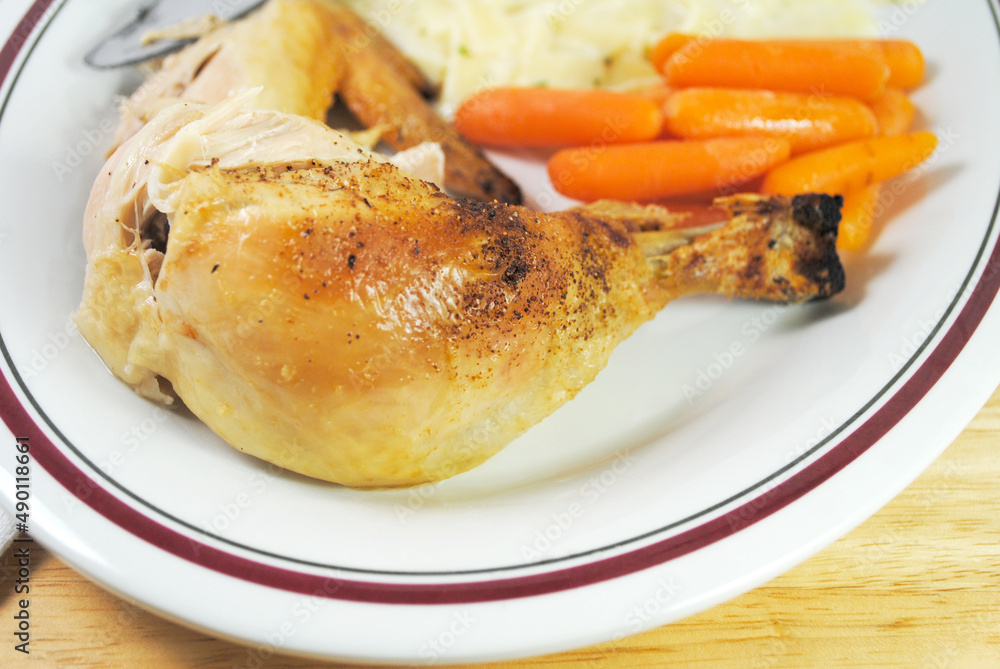 Close Up of a Roasted Chicken Leg Serve on a Plate with Other Healthy Foods Close Up of a Roasted Chicken Leg Serve on a Plate with Other Healthy Foods