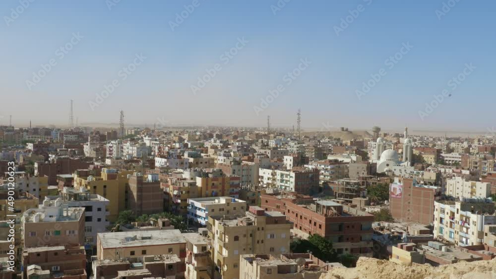 Urban panorama of Hurghada. Top view of buildings, houses, trees of arab city. Cityscape of tourist centre located on Red Sea coast. Townscape, residential district. Movement from left to right Urban panorama of Hurghada. Top view of buildings, houses, trees of arab city. Cityscape of tourist centre located on Red Sea coast. Townscape, residential district. Movement from left to right