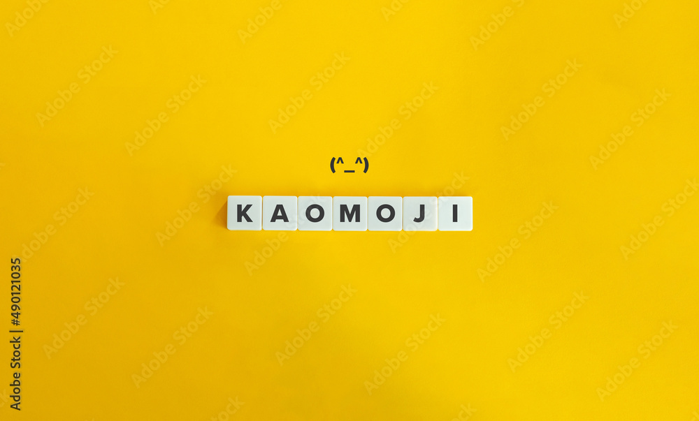 Kaomoji Word on Letter Tiles and Emoticon on Yellow Background. Minimal Aesthetics. Kaomoji Word on Letter Tiles and Emoticon on Yellow Background. Minimal Aesthetics.