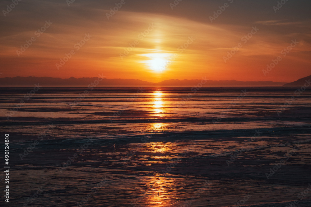 sunset over the lake Baikal. Listvyanka, Russia, february 2022.