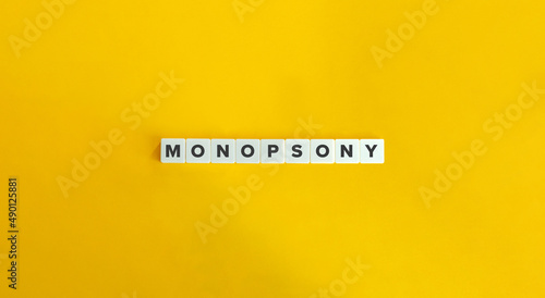 Monopsony Word on Letter Tiles on Yellow Background. Minimal Aesthetics.