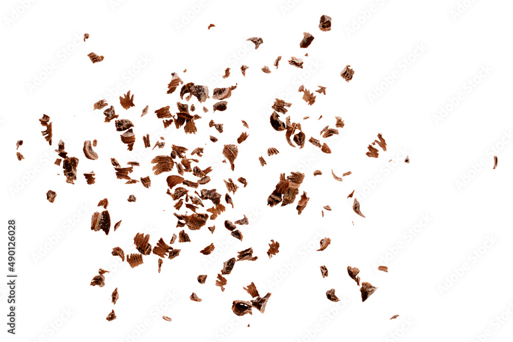 Grated chocolate chips on a white background, top view. Chocolate chips on a white background, top view. Pieces of grated chocolate isolated on white background, top view.