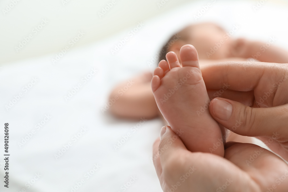 Mother massaging her cute baby with oil, closeup Mother massaging her cute baby with oil, closeup