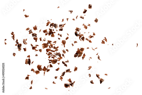 Grated chocolate chips on a white background, top view. Chocolate chips on a white background, top view. Pieces of grated chocolate isolated on white background, top view.