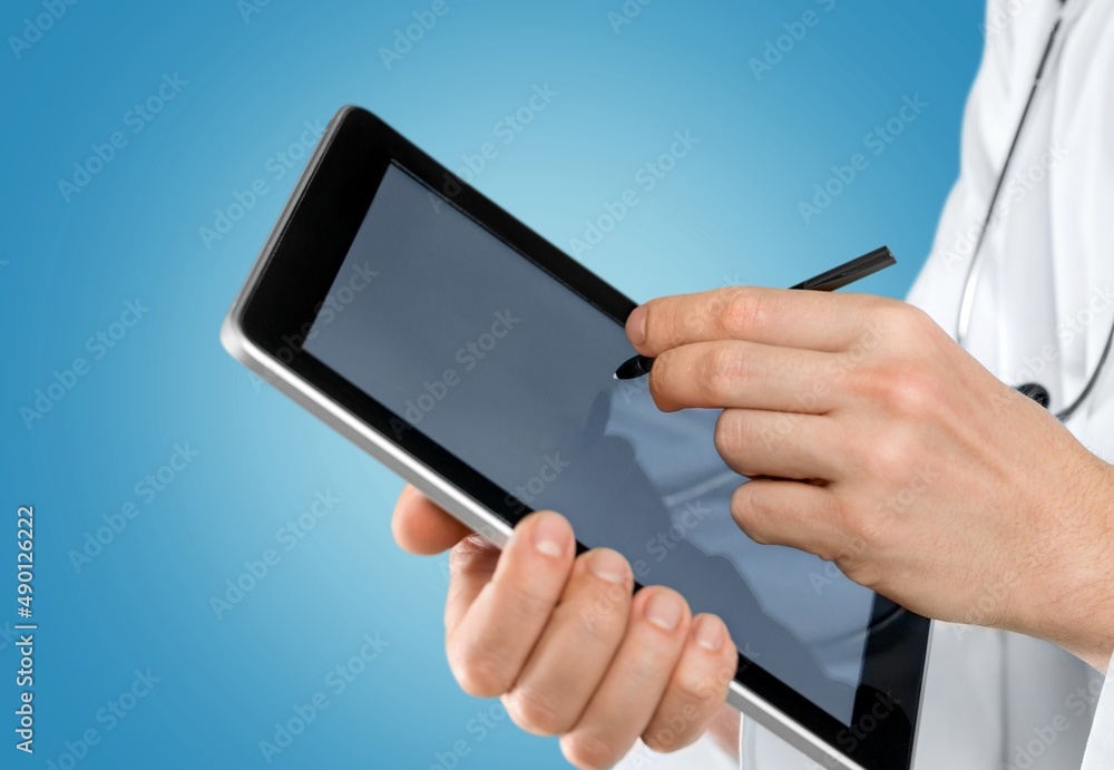 Beautiful young doctor, with a tablet for records. Medical student general practitioner. The concept of medical education Beautiful young doctor, with a tablet for records. Medical student general practitioner. The concept of medical education