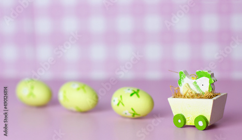 Easter card with chick and eggs on pink background with copyspace