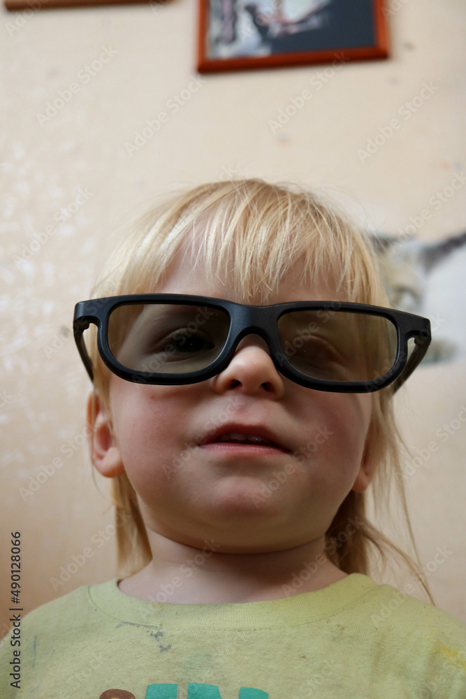 portrait of a funny blond child infant in dark glasses portrait of a funny blond child infant in dark glasses