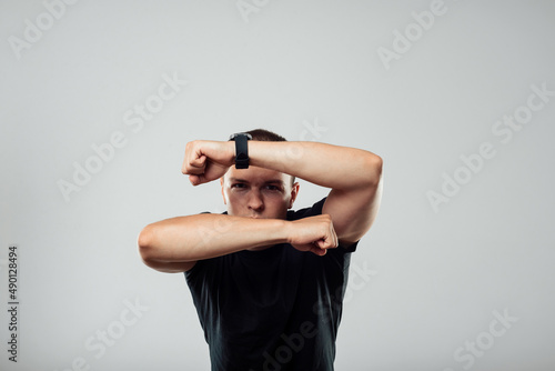 Valokuva Man in black t-shirt with black clock white background