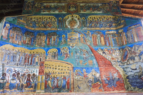 Painted wall at Voronet Monastery in Voronet, Bucovina, Romania. Representation of the Last Judgment Day on the west wall at monastery. photo