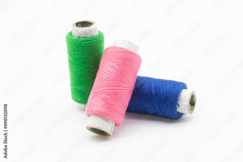 Colorful yarn on spool, yarn on tube, cotton, wool, linen thread, polyester selective focus on red spool Colorful yarn on spool, yarn on tube, cotton, wool, linen thread, polyester selective focus on red spool