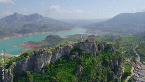 medieval Andalusian white village of Zahara de la Sierra near a blue lake, Iberian landmark and Spanish tourist destination. High quality 4k footage