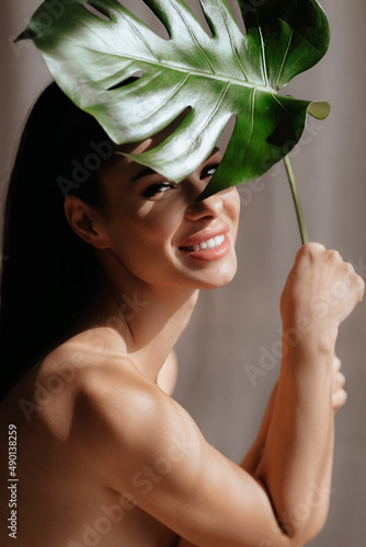 Beautiful happy Ukrainian woman  holding a green leaf. The power of female natural beauty. Beauty of our Ukrainian women  photo