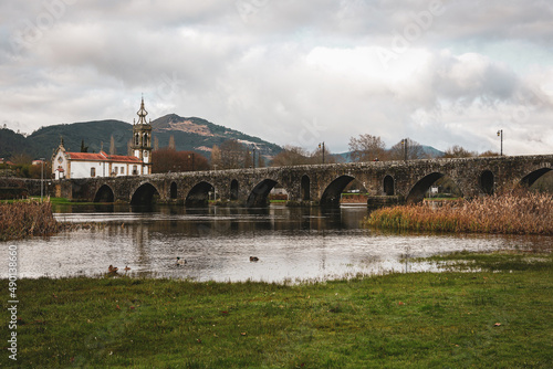 Distant view of the Ponte de Lima bridge on a gloomy day in Portugal photo