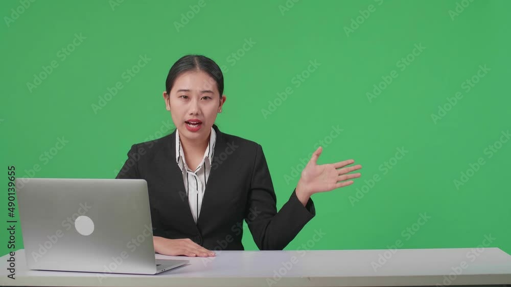 Live News Studio With Professional Asian Female Anchor And Her Computer Pointing On Something While Reporting On The Events Of The Day On The Green Screen
Live News Studio With Professional Asian Female Anchor And Her Computer Pointing On Something While Reporting On The Events Of The Day On The Green Screen