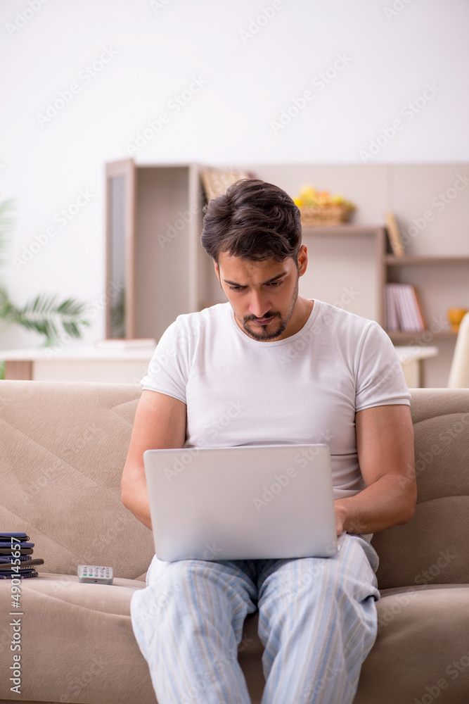 Young male employee working from home during pandemic Young male employee working from home during pandemic