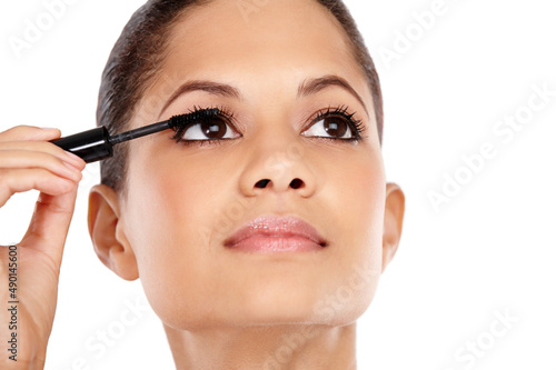 Luscious lashes. Attractive young woman applying mascara to her eyelashes.
