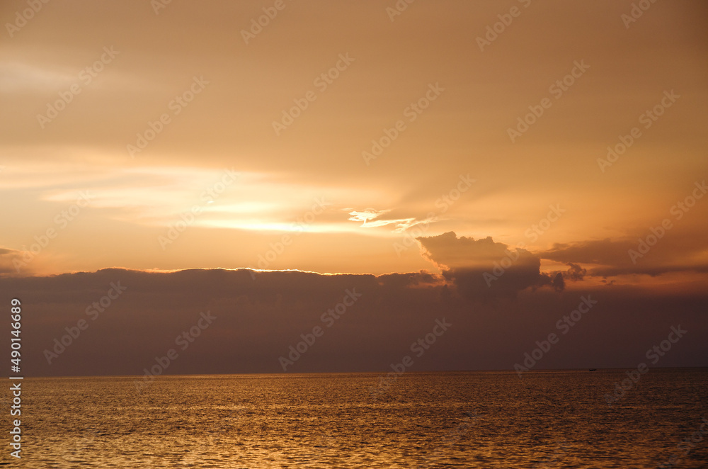 Picturesque seaside resort town in Slovenian coast against orange sunset sky in summer. Scenic view of Adriatic sea in the evening. Travel concept