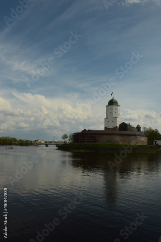 medieval white castle in russia on the water against the background of clouds in cloudy weather free space