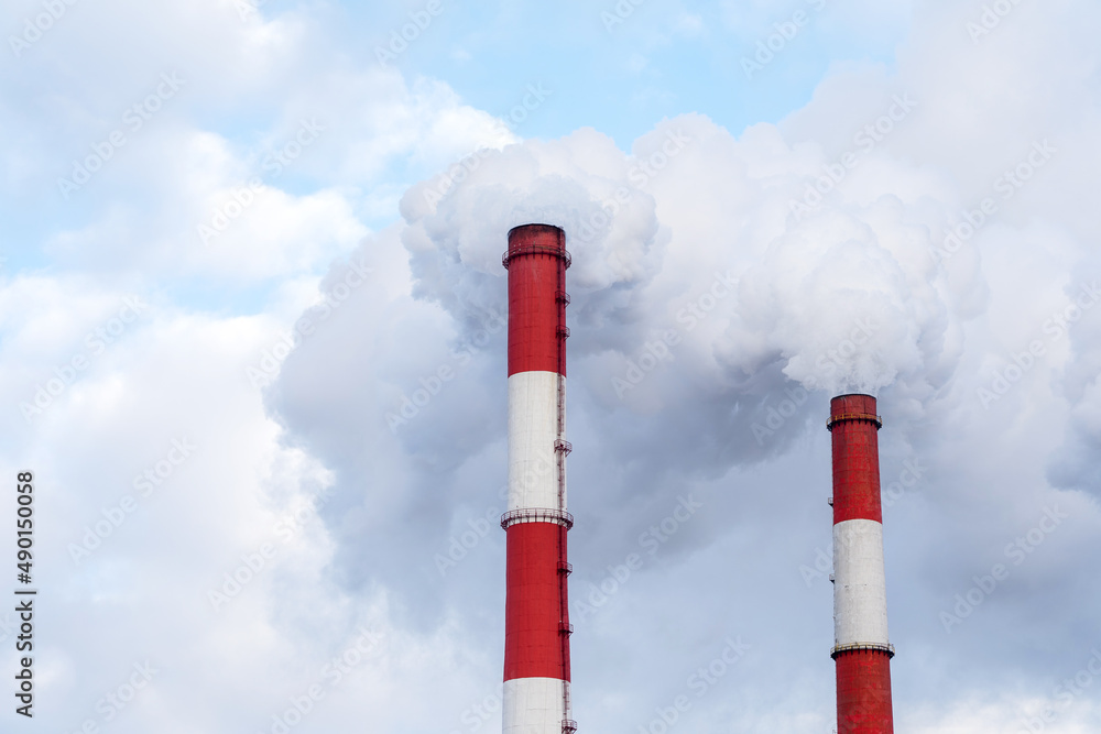 Dark toxic smoke clouds coming out of factory chimney. Two pipes with smoke Dark toxic smoke clouds coming out of factory chimney. Two pipes with smoke