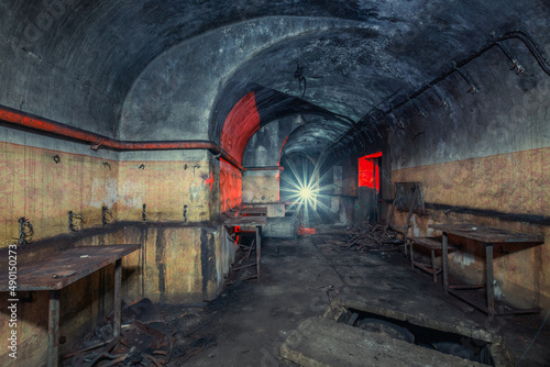 Exploration of an old bunker from the second world war with a flashlight photo