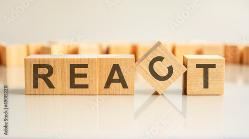 Fotografija react text on a wooden blocks, gray background.