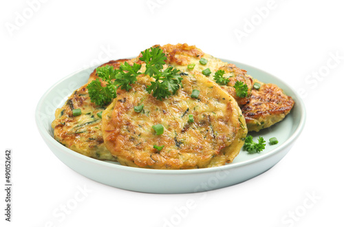 Delicious zucchini fritters with curly parsley on white background