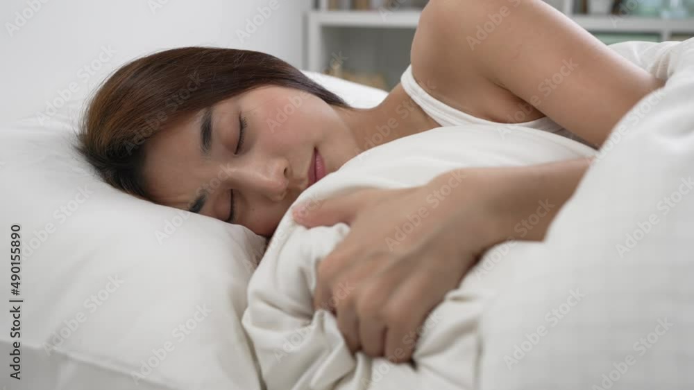 Young beautiful woman sleeping in her bed and relaxing in the morning Young beautiful woman sleeping in her bed and relaxing in the morning