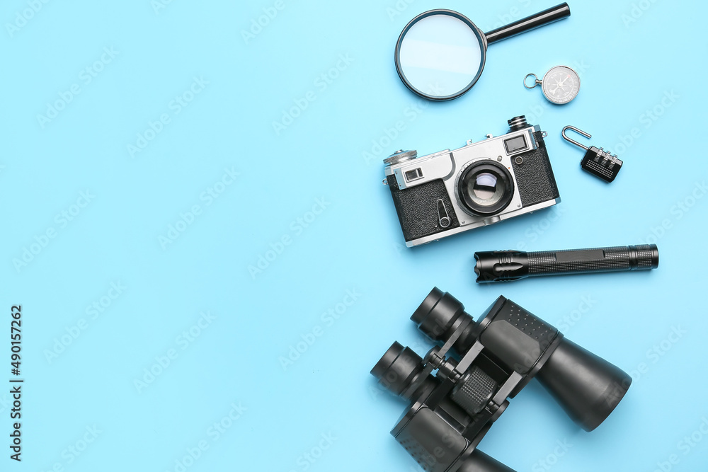 Set of travel items with photo camera on color background